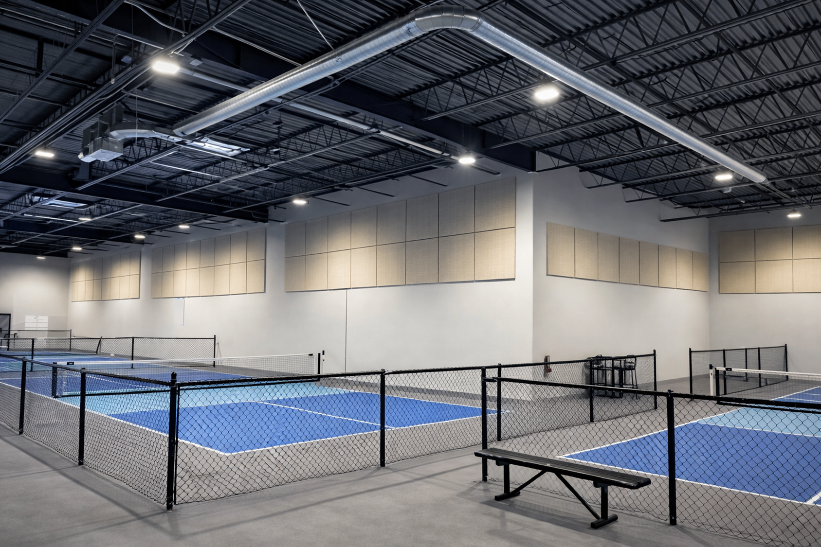 Indoor pickleball facility with SLN/CR Core acoustic panels installed on walls and ceiling